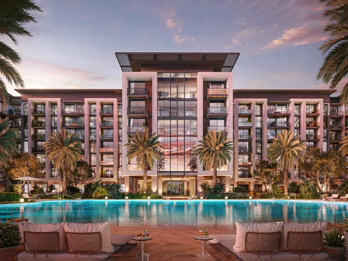 Wide architectural view of the exterior of Belgravia Gardens by Ellington Properties, showing the central courtyard, swimming pool, and modern apartment buildings under a clear sky.